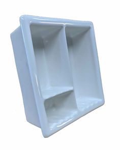 an empty white shelf with three compartments on the front and one in the back, against a white background