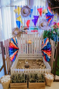 an indoor sandbox garden with colorful flags and decorations