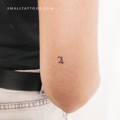 a woman's arm with a small tattoo on the back of her left arm