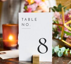 a table number sitting on top of a wooden table