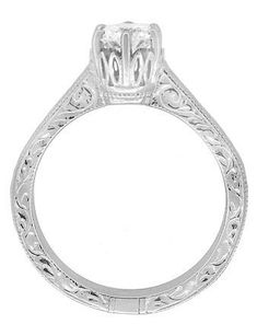 an antique style diamond engagement ring with filigrees