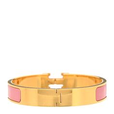 This is an authentic HERMES Enamel Narrow Clic Clac H Bracelet GM in Rose Nacarat. This is a chic bracelet that features a gold plated band with a hinge on one side and opens with a swivel Hermes "H" on the prominent side. Around the band is a strip of light pink enamel set in the metal. H Bracelet, Chic Bracelet, Pink Enamel, Light Pink, Gold Plate, Plating, Bracelet, Band, Pink