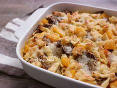 a casserole dish filled with pasta and meat