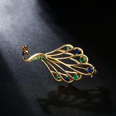 The peacock is a symbol of good luck, which is a bird of the kindest, wisest, most loving freedom and peace. In Greek mythology, the peacock is the symbol of the goddess Hera. It is said, this elegant peacock brooch will say all that about yourself. Exquisitely crafted with shimmering stones, it will match perfectly with your fall/winter outfits and beyond.Weight: 4.94 gWidth: 39.25 mmHeight: 20.7 mmThickness: 5.3 mmMaterial: Plating Color: Peacock Brooch, Gold Brooches With Peacock Design As Gift, Mythology Jewelry, Royal Indian, Peacock Jewelry, Peacock Design, Sterling Silver Brooch, Silver Brooch, Quality Jewelry