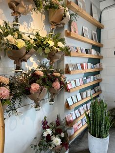 flowers and cards are hanging on the wall next to each other in flowerpots