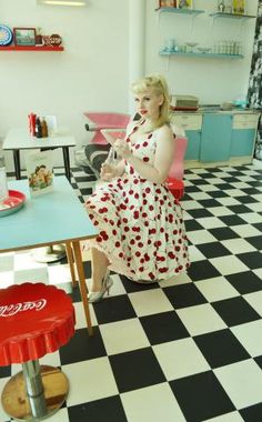 a woman in a dress sitting at a table