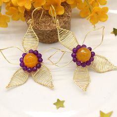 Large and beautiful are our handcrafted ROSELYN earrings in the shape of a flower delicately wrapped in golden copper wire accompanied by vibrant yellow agate and purple chalcedony gemstones giving a touch of color to each piece.
MEASUREMENTS
- Length Approx.: 3 Inch
- Width Approx.: 2.5 Inch
* Weight each earrings Approx. : 0.25 oz.
.
#handmadejewelry #flowerearrings #dangleearrings #bohoerrings #bohojewelry #gemstoneearrings #gemstonejewelry #wirejewelry #wirewrappedjewelry #giftforher Wire Wrapped Beaded Earrings As Gift, Gold Beaded Flower-shaped Earrings, Gold Flower Beaded Earrings As Gift, Gold Beaded Flower Earrings, Gold Round Beads Flower Earrings As Gift, Gold Flower Earrings With Round Beads For Gift, Handmade Flower Jewelry For Crafting, Purple Wire Wrapped Beaded Earrings For Gift, Artisan Wire Wrapped Beaded Earrings