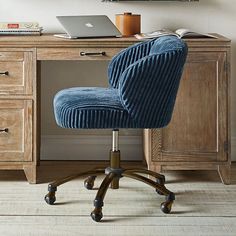 a blue chair sitting in front of a wooden desk