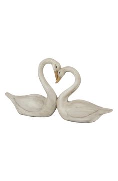 two white swans making a heart shape with their necks