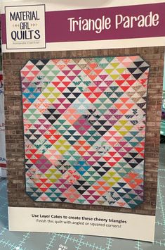 the book is open to show it's colorful quilting pattern and instructions on how to