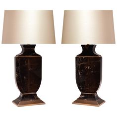 a pair of brown marble lamps with white shades