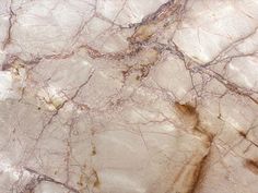 the marble is brown and white with gold veining on it's edges,