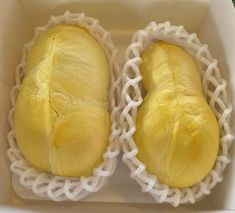 two loaves of bread sitting in a box