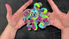 a hand holding an octopus made out of crochet