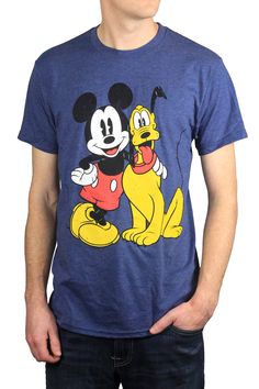 a man wearing a mickey mouse t - shirt