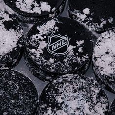 black and white photo of hockey puckers covered in powdered sugar on top of each other