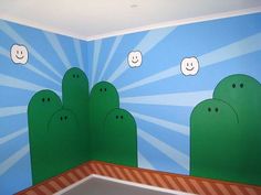 a room painted in blue and green with cartoon trees on the wall, clouds above them