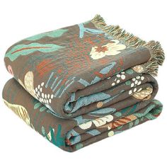 two blankets folded on top of each other with flowers and leaves printed on the blanket