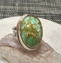 This incredible Royston Turquoise stone is surrounded by 14k gold filled sterling silver. The rest of the metal used to make the ring is sterling silver. It is a size 8 and can be sized up to 3/4 of a size. Spiritual Sterling Silver Turquoise Ring With Large Stone, Heirloom Style Turquoise Sterling Silver Ring, Artisan Turquoise Ring With Large Stone, Artisan Turquoise Ring With Large Stone Collectible, Oval Turquoise Emerald Ring For Collectors, Turquoise Healing Ring With Large Stone, Artisan Turquoise Ring With Natural Stones For Anniversary, Spiritual Oval Turquoise Ring With Natural Stones, Spiritual Oval Turquoise Gemstone Ring