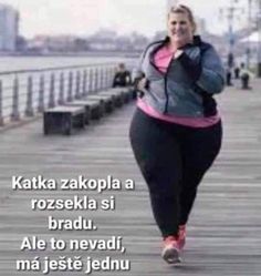 a woman is running on the boardwalk with her hand in her mouth and another person behind her