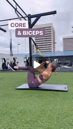 a woman doing an exercise on a mat in front of a sign that says core and biceps