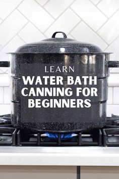 a black pot sitting on top of a stove with the words learn water bath canning for beginners