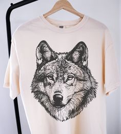 Vintage 90s Wolf Shirt ⭐ Welcome to K & K Custom Tees! ⭐  - Indulge in pure comfort with our Comfort Colors Shirt. Soft, relaxed, and available in a variety of colors! ⭐SHIRT DETAILS⭐  -High Quality fabric  -100% ring-spun US cotton -Designed and printed in the USA  ⭐ PLEASE NOTE ⭐ -For an oversized look, we suggest to size up 1-2 sizes. These shirts run like standard unisex tees. Please see size chart for a more fitted look!  -Colors may vary based on your monitor or screen display! ⭐CARE INSTR Short Sleeve Wolf Design Tops For Streetwear, Wolf Design Short Sleeve Tops For Streetwear, Short Sleeve Tops With Wolf Design For Streetwear, Graphic Tee With Wolf Design For Streetwear, Wolf Design Graphic Tee For Streetwear, Streetwear Graphic Tee With Wolf Design, Graphic Tee With Wolf Design Short Sleeve, Wolf Design Graphic Tee With Short Sleeves, Graphic Tee With Wolf Design, Short Sleeve