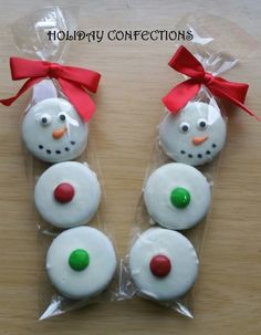 four frosted snowman cookies wrapped in cellophane