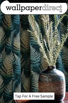 a vase sitting on top of a wooden table next to a wallpaper direct advertisement