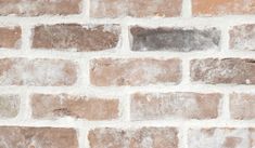 a brick wall with white and brown bricks