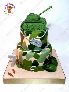 a camouflage cake with green army tanks on it