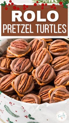 chocolate pretzel turtles in a white bowl with holly wreaths and red berries