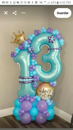 the number thirteen balloon is decorated with blue and purple balloons