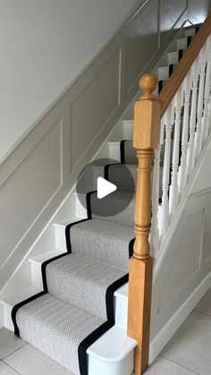 a white staircase with black and white carpet