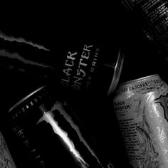 black and white photograph of two beer cans