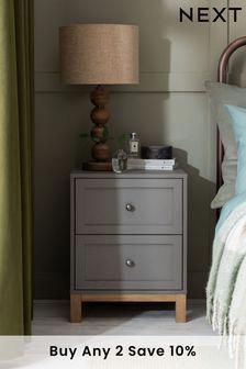 a nightstand with a lamp next to it and a bed in the background that says, buy any 2 save 10 %