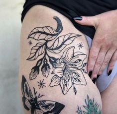 a woman's thigh with flowers and butterflies on it