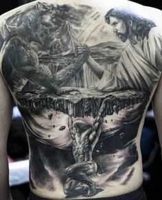 the back of a man's body with tattoos on it, and an image of jesus