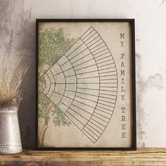 an old family tree is displayed on a shelf next to a vase with dried grass in it