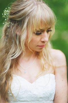 a woman with long blonde hair wearing a wedding dress