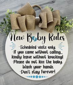 a sign that says new baby rules on it