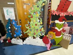 the grino christmas tree and other decorations are displayed in front of a classroom door