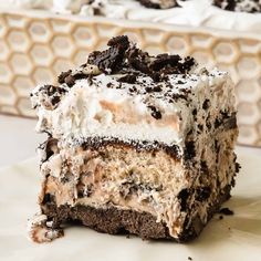 a close up of a piece of cake on a plate with ice cream and oreo