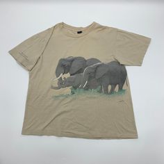 "Vintage 80s Whole Earth Provision Company Elephant T-shirt. Size tag is missing fits like a Medium. Single Stitch Made in USA. Flaw shirt has major discoloring due to age see photos for detail Measurements Pit to Pit 21.5\" Length 25\" IKU: 22.8.3.14" Cheap Vintage Unisex Tops, Vintage T-shirts Lightinthebox, Cheap Vintage Washed T-shirt, Cheap Vintage Shirt With Relaxed Fit, Cheap Relaxed Fit Shirt With Vintage Print, Cheap Vintage Stonewashed T-shirt, Cheap Vintage Medium Wash Shirt, Affordable Vintage Print Shirt, Dinosaur Shirt Vintage