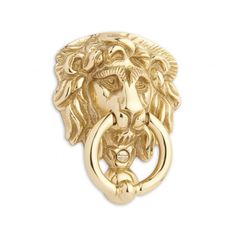 a gold lion head door knocket on a white background