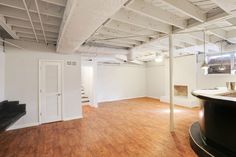 an empty room with hard wood floors and white walls