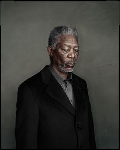 an older man in a suit and tie looking at the camera with his eyes closed