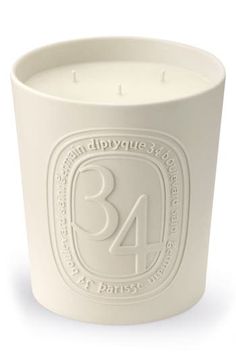 a white candle holder with the number 34 printed on it's front and sides