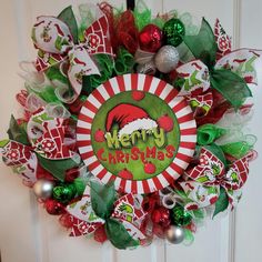 Large MERRY CHRISTMAS Wreath 💥Get ready for the Christmas holiday with this large Grinch-inspired wreath to decorate your home. This wreath is full of holiday cheer and is perfect to get you into the Christmas spirit! This wreath is perfect for a single door, but also large enough to accommodate homes with double doors. This handcrafted wreath is decorated with white, red, and green deco mesh along with lots of Grinch-inspired ribbon.  This wreath is finished off with matching Christmas ornaments and a  sign in the center that reads "Merry Christmas." Don't miss out on this unique one-of-a-kind wreath to decorate your home! 🔨Assembly: Our shop selects from a vast array of quality materials to assemble our handcrafted products. Each item is made to order and is crafted with care especiall Merry Christmas Wreath, Single Doors, Door Wreath Hanger, A Sign, Deco Mesh, Double Doors, Christmas Wreath, Christmas Spirit, Ribbon Bows