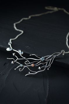 ITEM DESCRIPTION: The size H 5 cm x W 8 cm (2 x 3 inch). Weight - 8 g. You can buy it with a silver chain of different lengths. I made this unusual contemporary necklace of sterling silver, blue topaz, red sunstone, and labradorite. It's like twigs with berries and leaves. Very detailed and large necklace. It just looks incredible! This plant necklace is really worthy of being in your precious collection. Expect many compliments on this! Ooak jewelry made by eco-friendly materials. This handmade Sterling Silver Pendant Necklace With Jewels, Unique Pendant Necklace With Jewels, Nature-inspired Sterling Silver Necklaces With Unique Variations, Nature-inspired Silver Necklace With Gemstone, Unique Sterling Silver Necklaces With Jewels, Unique Sterling Silver Necklace With Jewels, Ursula Jewelry, Plant Necklace, Winter Berries